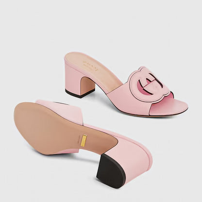Pink high-heeled shoes with a buckle design on a light gray background