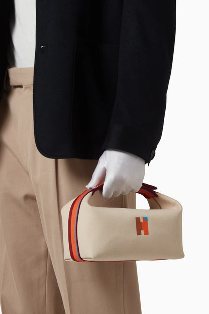 model holding a Hermès Small Bride-a-Brac H Pavillon Case Natural H104346Mv01