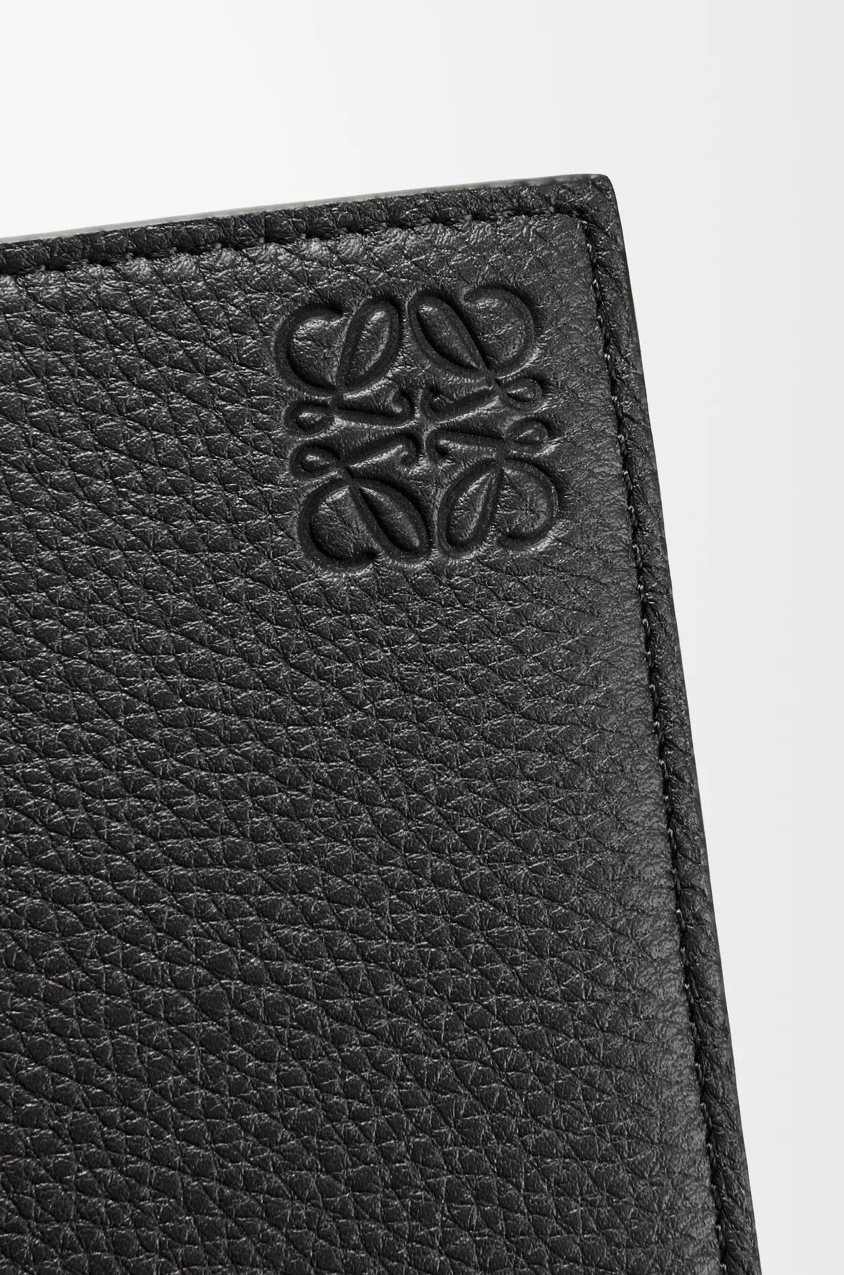 Close-up of a bLoewe Bifold Coin Wallet in Soft Grained Calfskin – Black C660501X03-1100 with a anagram logo on a white background
