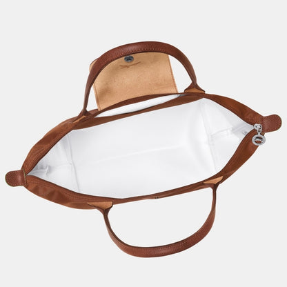 Longchamp Le Pliage Green M Tote Bag – Cognac L2605919504 with white interior on a light gray background