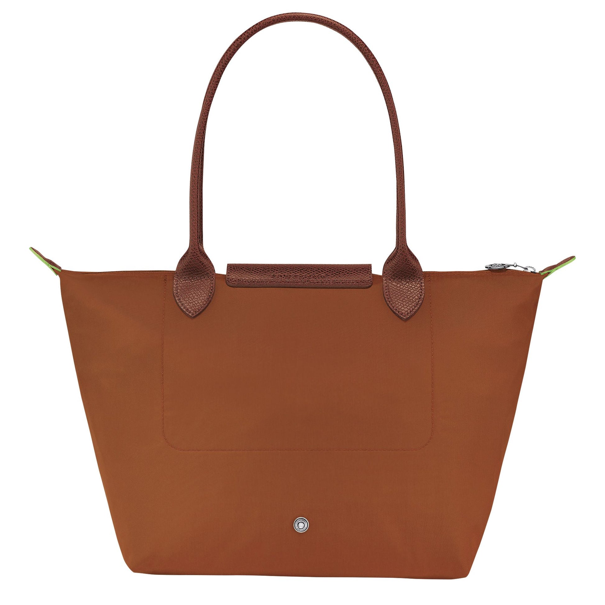 Behind Longchamp Le Pliage Green M Tote Bag – Cognac L2605919504 with leather handles on a white background