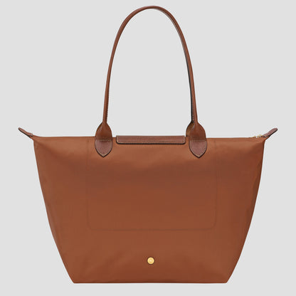 Longchamp Le Pliage Original L Tote Bag – Cognac L1899089504 with leather handles on a light gray background