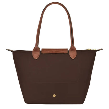 Behind Longchamp Le Pliage Original M Tote Bag Ebony L2605089P81 on a white background