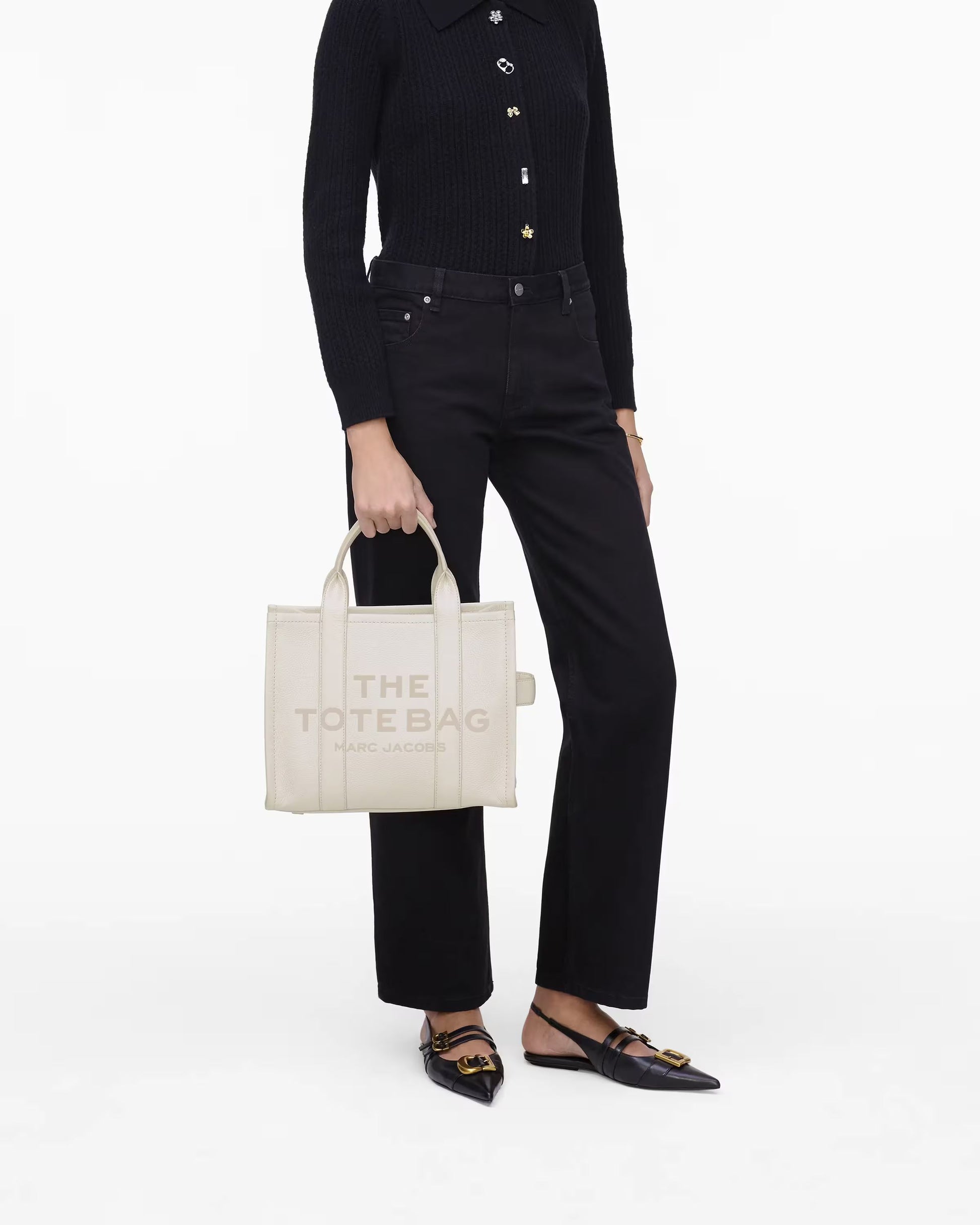person holding a Marc Jacobs The Leather Medium Tote Bag Cotton Silver H004L01PF21 140
