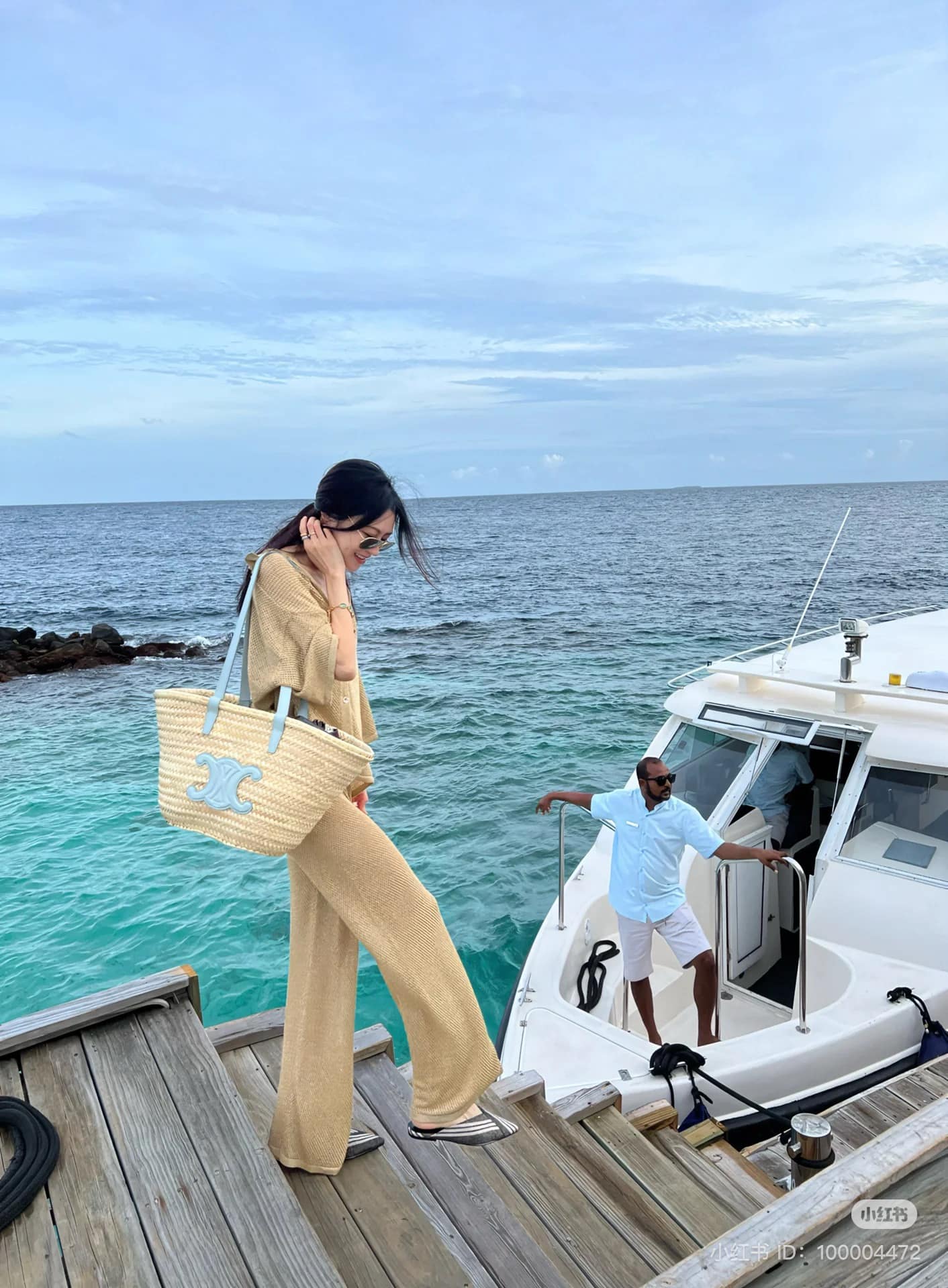 wearing MEDIUM CELINE PALE BLUE CLASSIC PANIER IN PALM LEAVES AND CALFSKIN 192622CGG.07PB