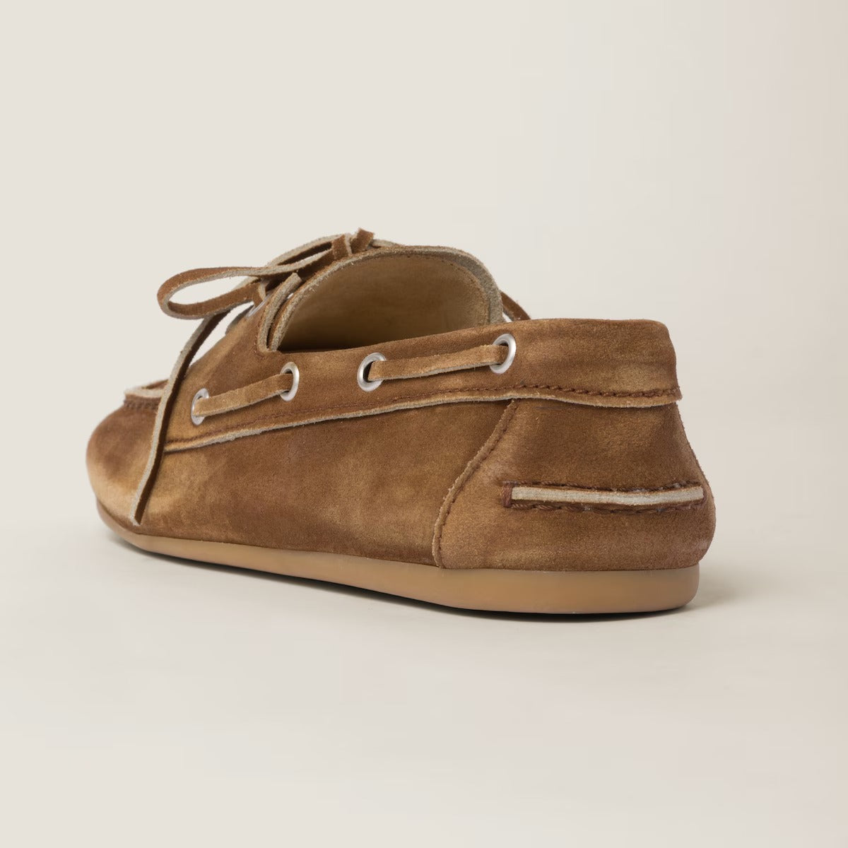 behind Miu Miu Faded Unlined Suede Loafers – Cinnamon 5D123E_Z5O_F0401_F_D005 on a beige background
