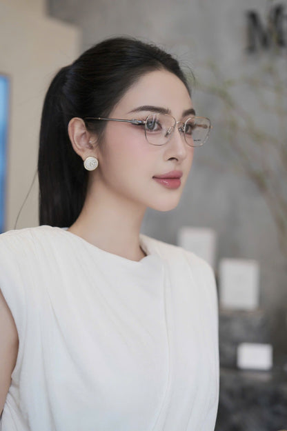 Woman wearing Miu Miu MU 50WV 1BC1O1 Eyeglasses and a white top in an indoor setting
