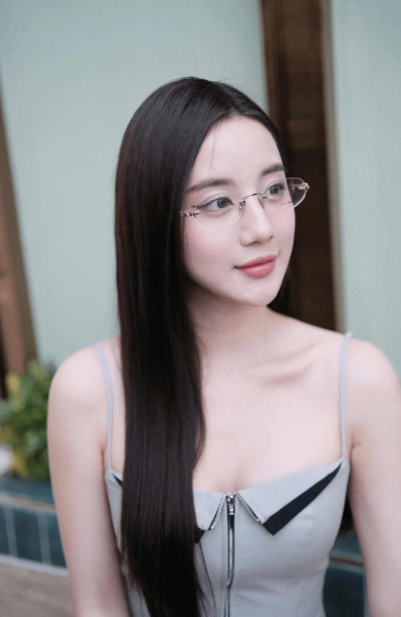 Woman wearing Miu Miu MU 53WV 1BC1O1 Eyeglasses with a neutral background