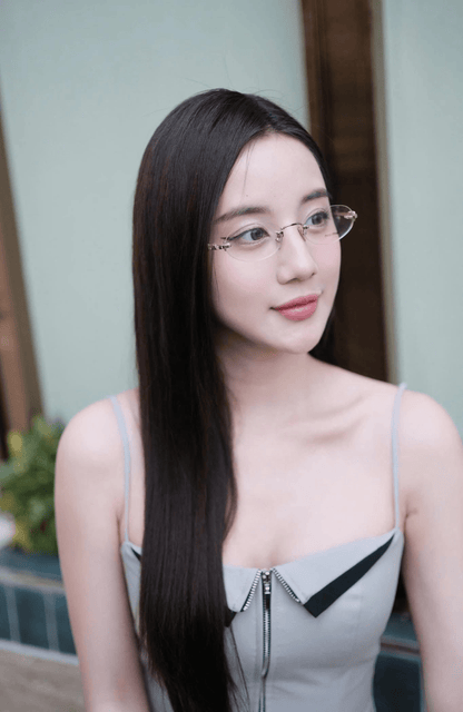 Woman wearing Miu Miu MU 53WV 1BC1O1 Eyeglasses with a neutral background
