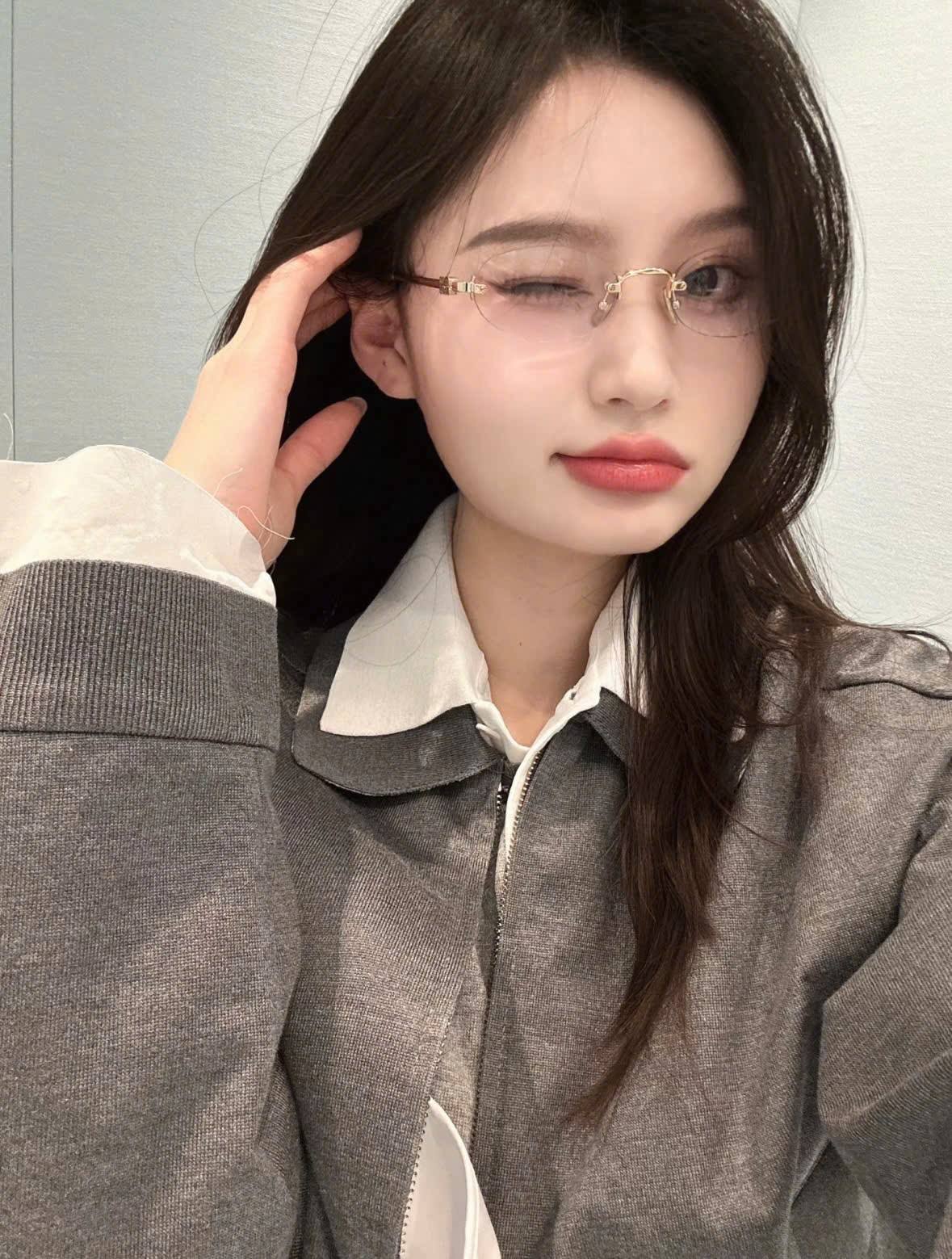 Person wearing Miu Miu MU 53WV 5AK1O1 Eyeglasses with a neutral background