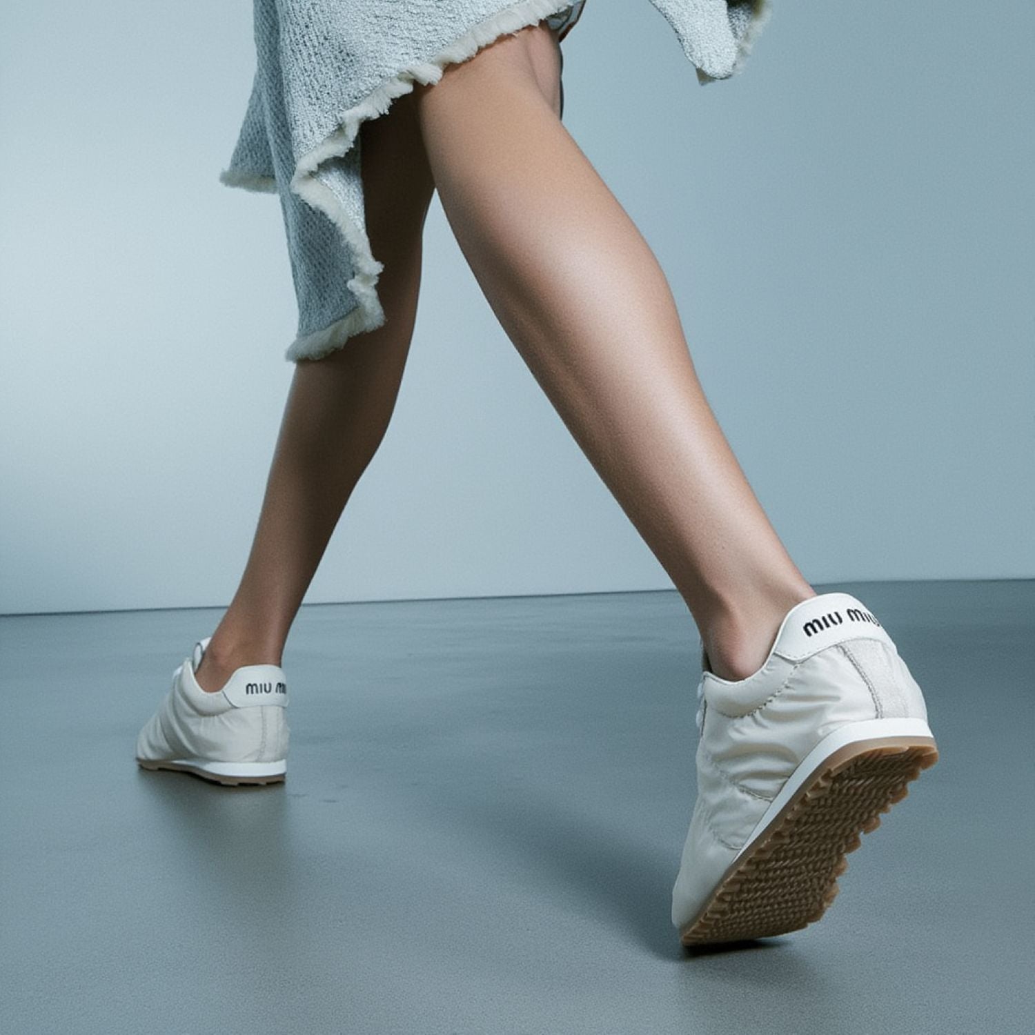 Miu Miu Plume Technical Fabric and Suede Sneakers – Ivory 5E114E_D7C_F0304_F_D005 with brown soles worn by a person on a gray floor.