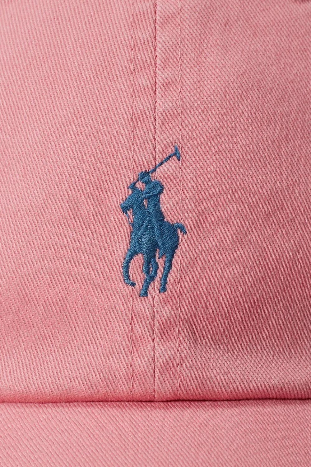 Pink cap with a blue embroidered logo on a pink background