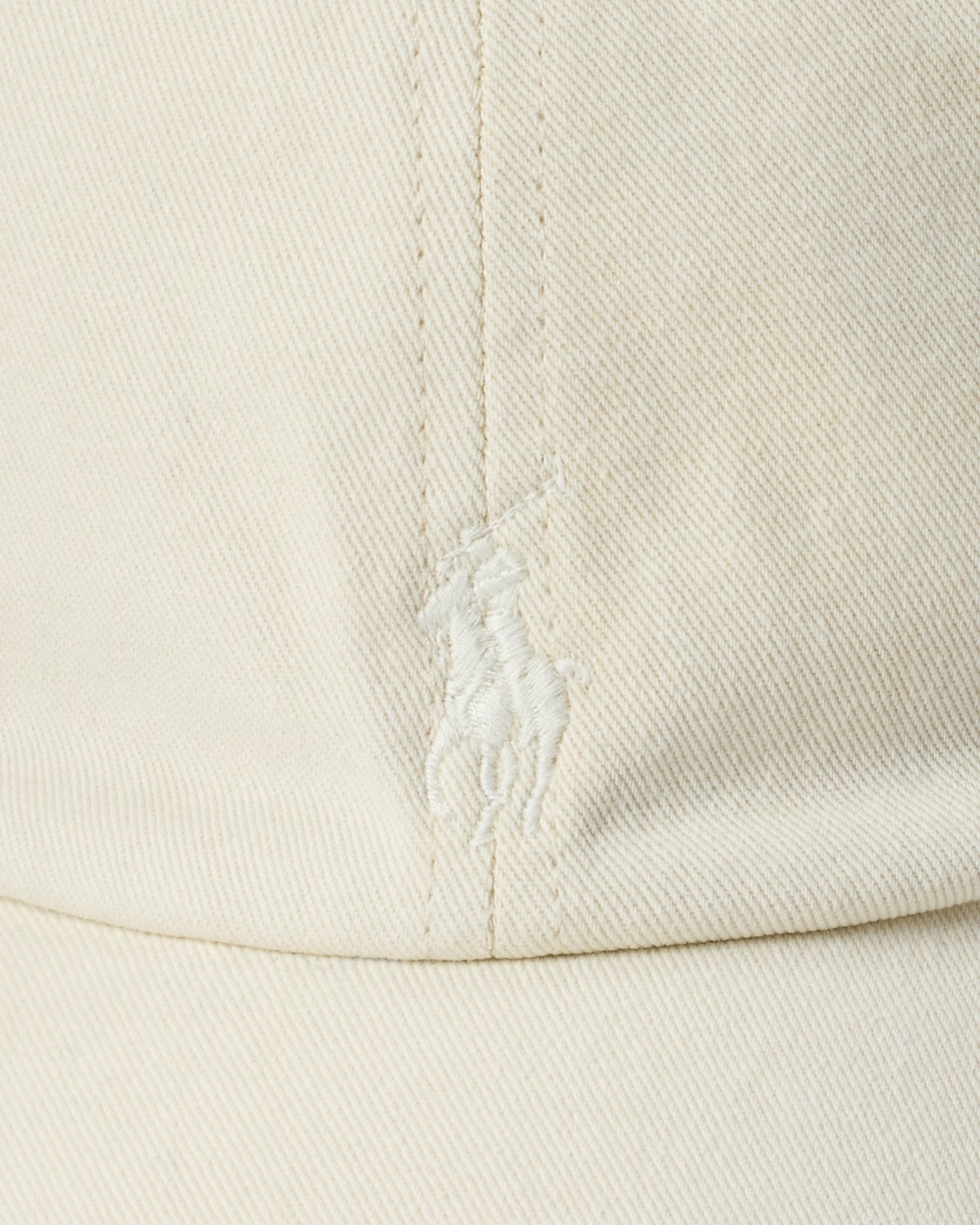 Close-up of a beige fabric with a brand logo on a white background