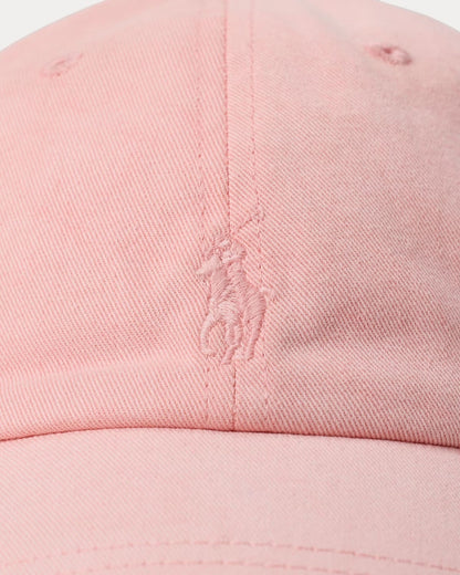 Close-up of a pink cap with a logo on a white background