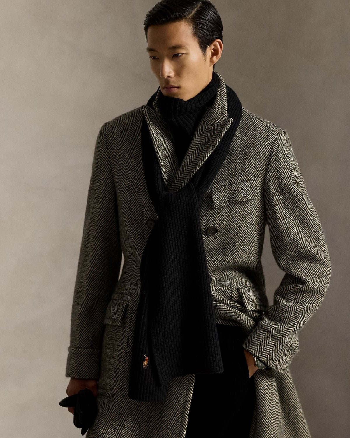 Man wearing a gray coat and Polo Ralph Lauren Rib-Knit Wool-Blend Scarf Black 449959353001 against a neutral background