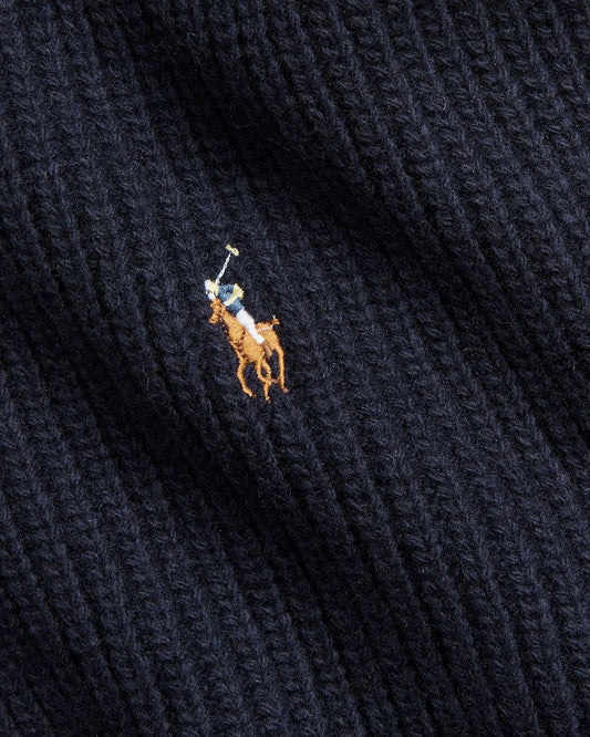 Close-up of a navy blue fabric with a embroidered logo featuring a polo player and horse.
