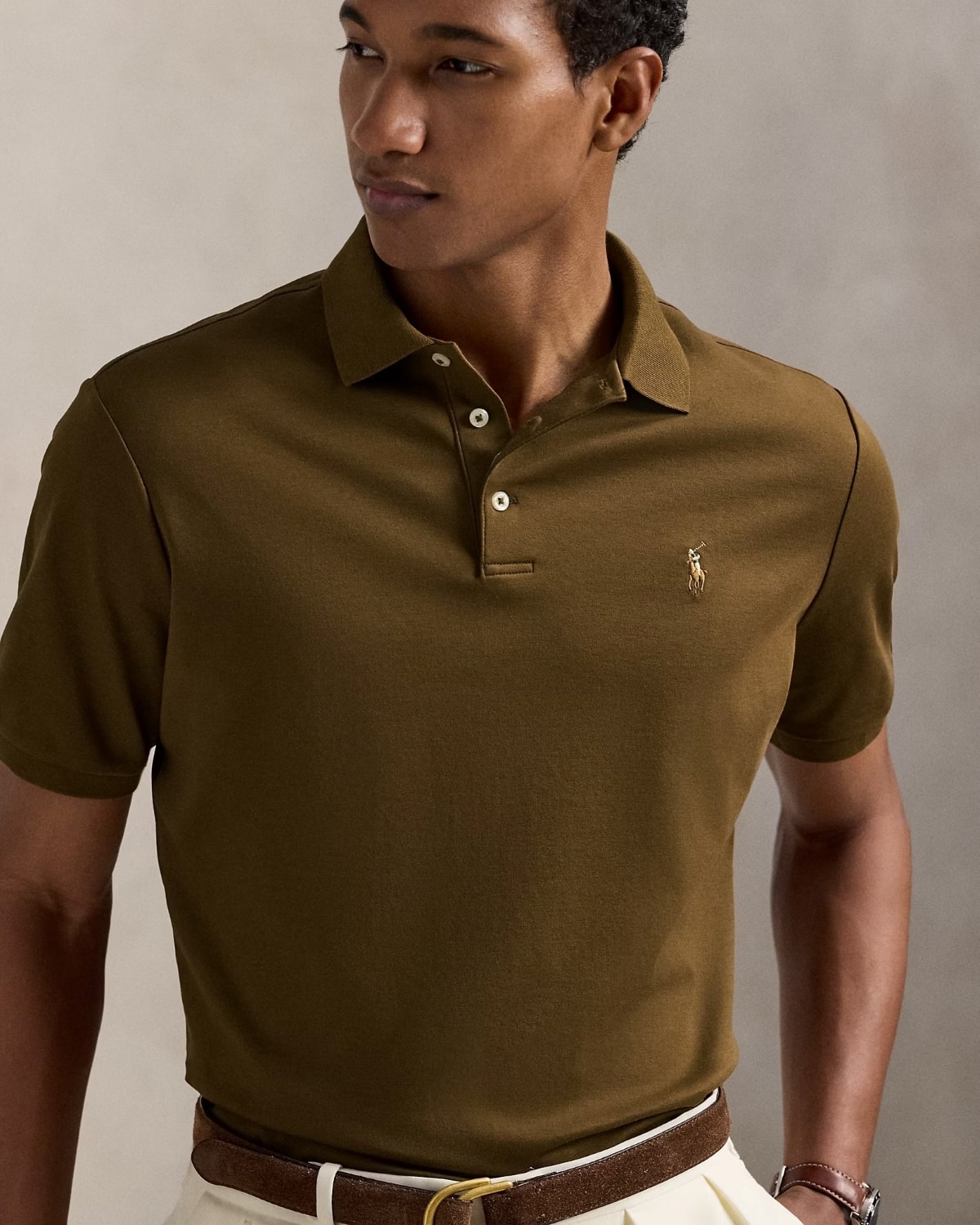 Man wearing a Polo Ralph Lauren Men’s Soft Cotton Polo Shirt Classic Fit – Nature Brown 710660606205 with a logo on a neutral background