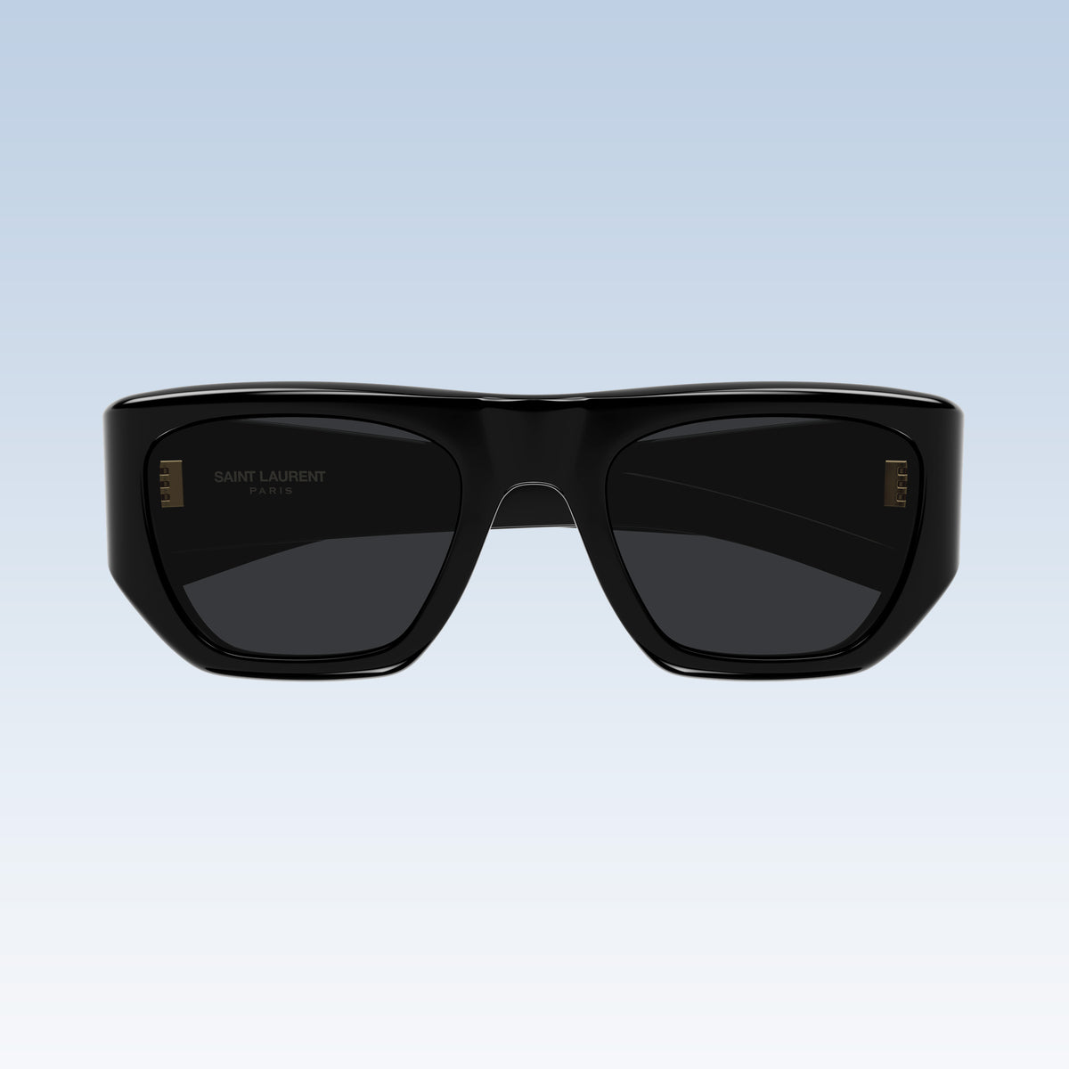 Saint Laurent SL 740 005 with a glossy black acetate frame and dark lenses, shown against a light blue gradient background.