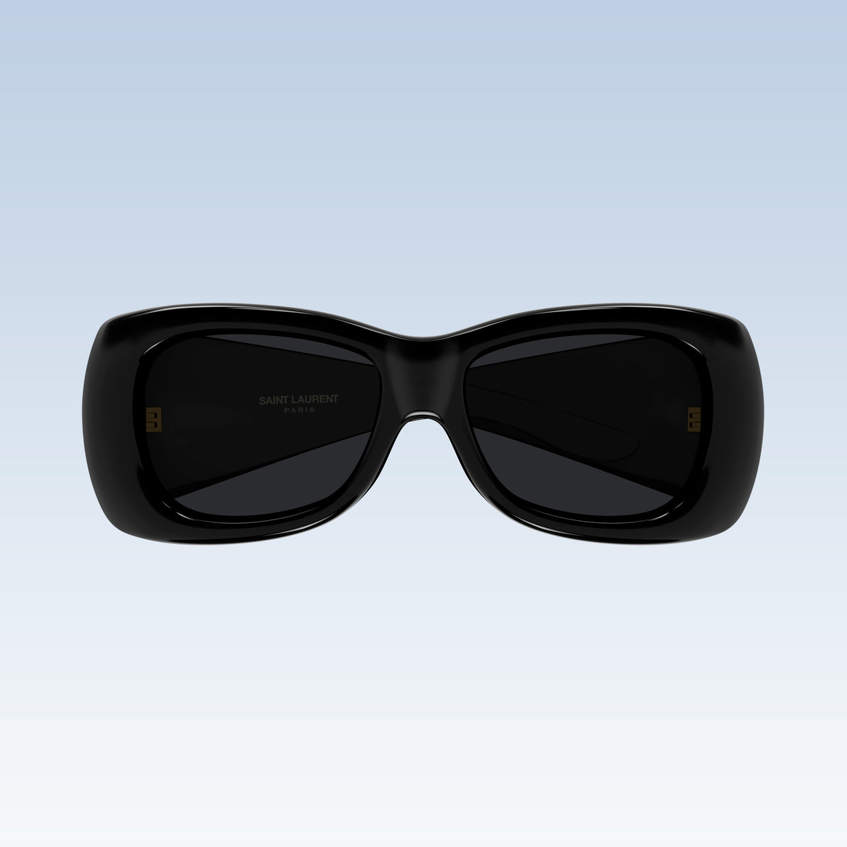 Saint Laurent SL 901 HOWL-001 with a glossy black frame and dark lenses, shown against a light blue gradient background.