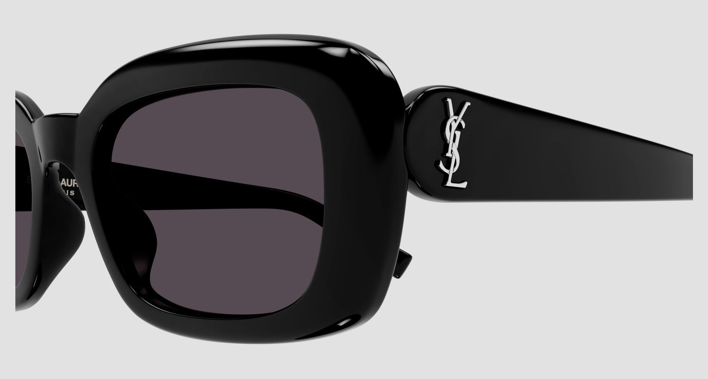 Close-up of Saint Laurent SL M130 Black Square Sunglasses with dark lenses and a white YSL logo on the temple, shown against a light gray background.