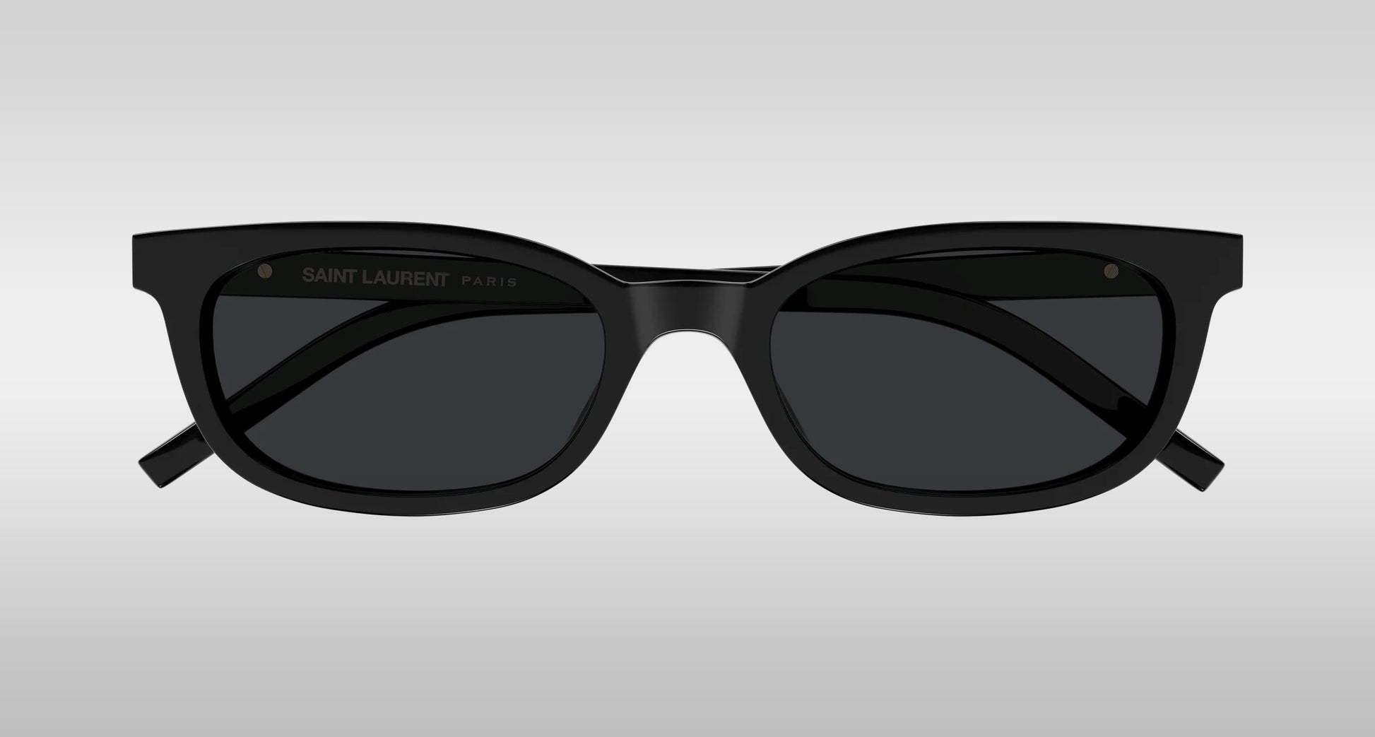 Saint Laurent SL M160-001 Black Oval Sunglasses with a matte frame and dark lenses, shown from the front on a light gray gradient background.
