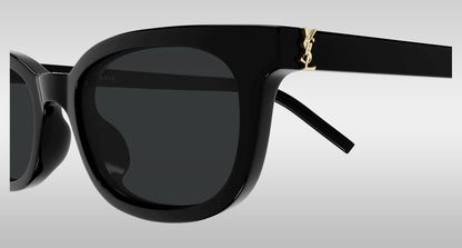 Saint Laurent SL M160-001 Black Oval Sunglasses with dark lenses and a gold YSL logo on the temple, shown against a light gray gradient background.