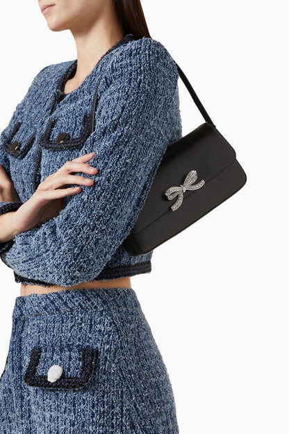 women wearing Self-Portrait Black Leather Baguette Bag PF24-309-B on shoulder with tweed set colour blue