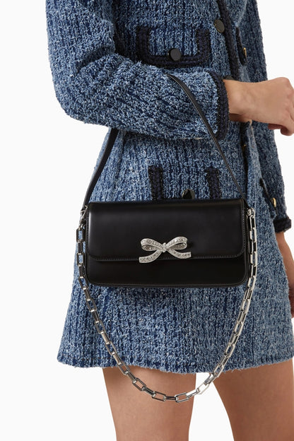 women holding Self-Portrait Black Leather Baguette Bag PF24-309-B in tweed blue & dark navy dress