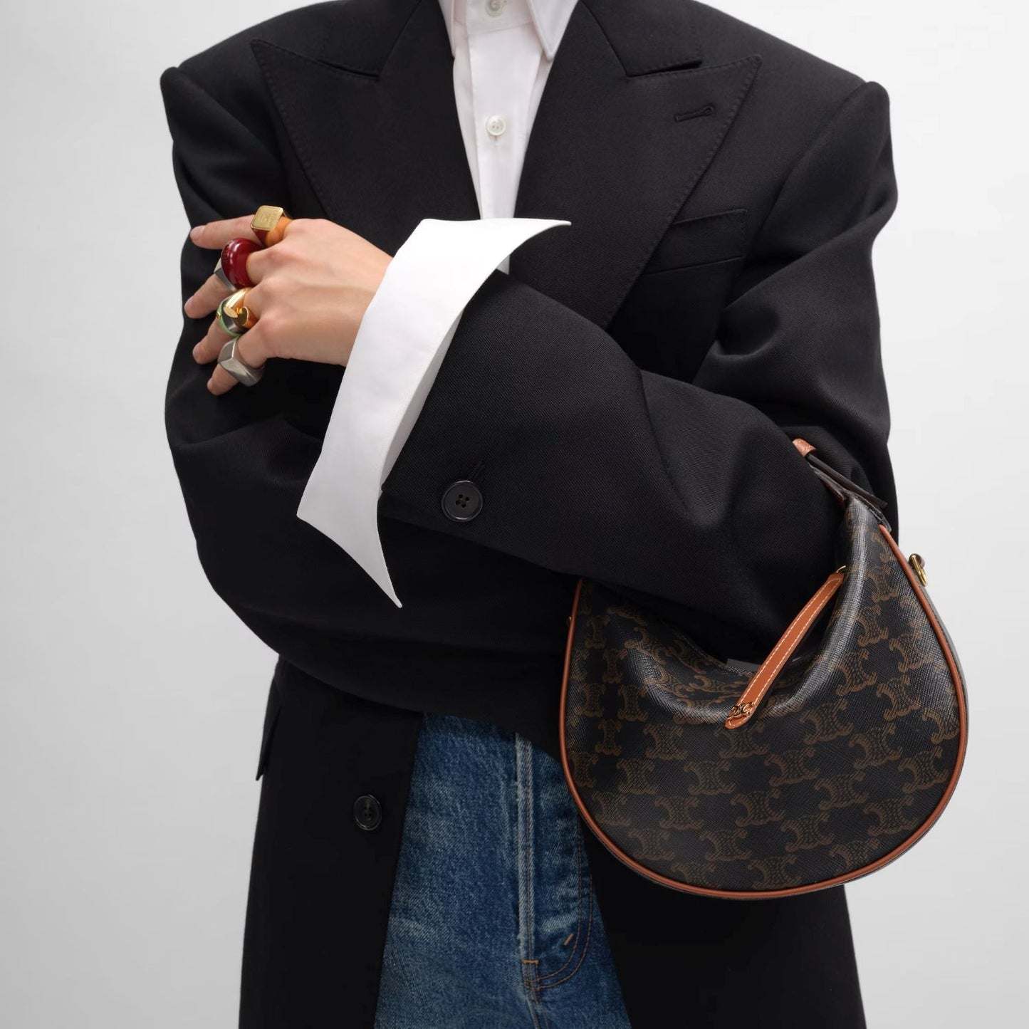 person holding Teen Celine Lulu in Triomphe Canvas and Calfskin Tan 120722FQM.04LU