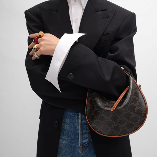 person holding Teen Celine Lulu in Triomphe Canvas and Calfskin Tan 120722FQM.04LU