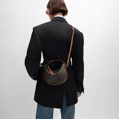 women wearing Teen Celine Lulu in Triomphe Canvas and Calfskin Tan 120722FQM.04LU with black & white suit