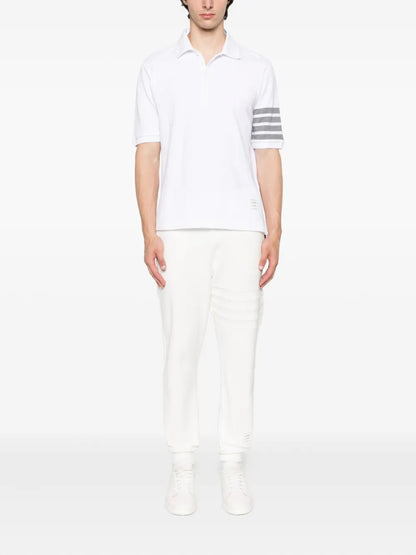 Person wearing a Thom Browne W/ 4-Bar in Sustainable Piqué White MJP136G 07976 100 on a white background