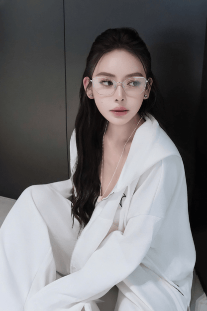 Woman wearing Tiffany TF1166 6001 Silver Eyeglasses and a white robe against a dark background