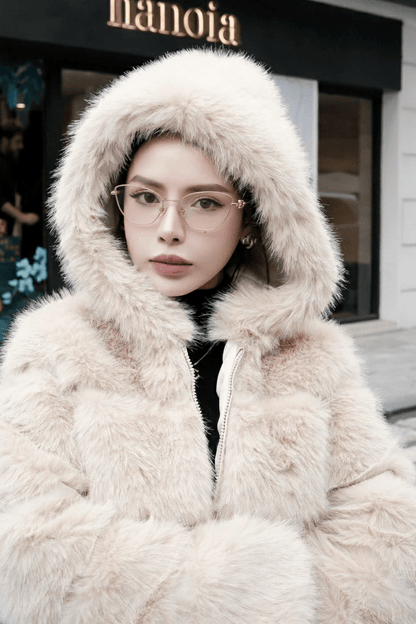 Person wearing a Tiffany TF1166 6021 Gold Eyeglasses and fluffy white hooded coat in front of a store with 'nanoia' branding.