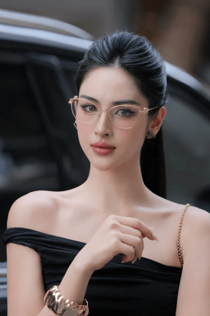 Woman wearing Tiffany TF1166 6021 Gold Eyeglasses and a black dress with a blurred background