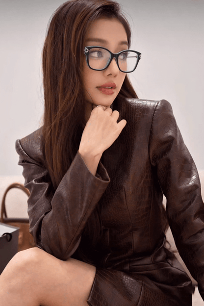 Woman wearing a brown leather outfit with Tiffany TF2266 8055 Blue Black Silver Eyeglasses against a neutral background
