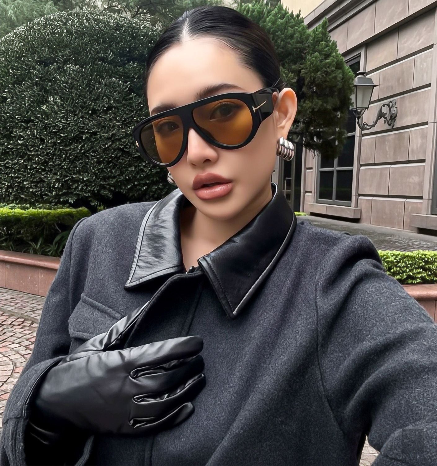 Woman wearing Tom Ford FT1044 01E Bronson Sunglasses and a dark coat outdoors