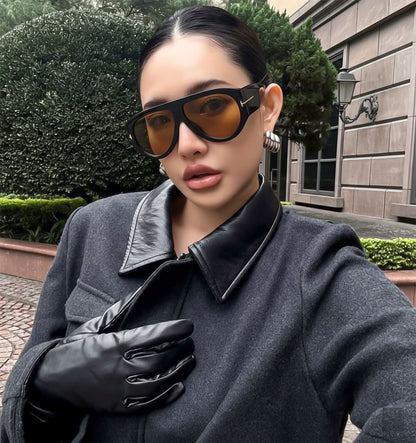 Woman wearing Tom Ford FT1044 01E Bronson Sunglasses and a dark coat outdoors