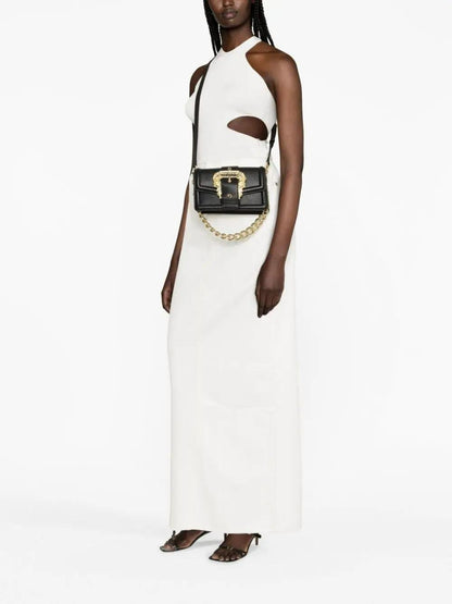 Woman wearing a white dress with a Versace Jeans Couture Chain Shoulder Bag 75VA4BFC ZS413 899 on a white background