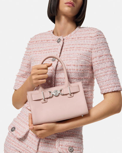 Woman holding a Versace Medusa '95 Small Tote Bag Light Pink 1013169-1A10795_1PT2P against a light background