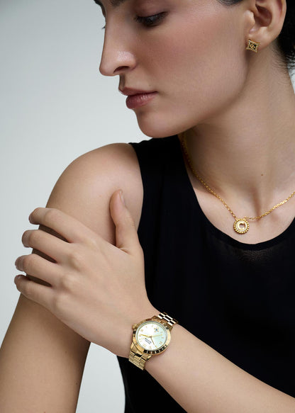 Woman wearing a Vivienne Westwood Bloomsbury Gold Watch vv152gdgd and necklace on a plain background