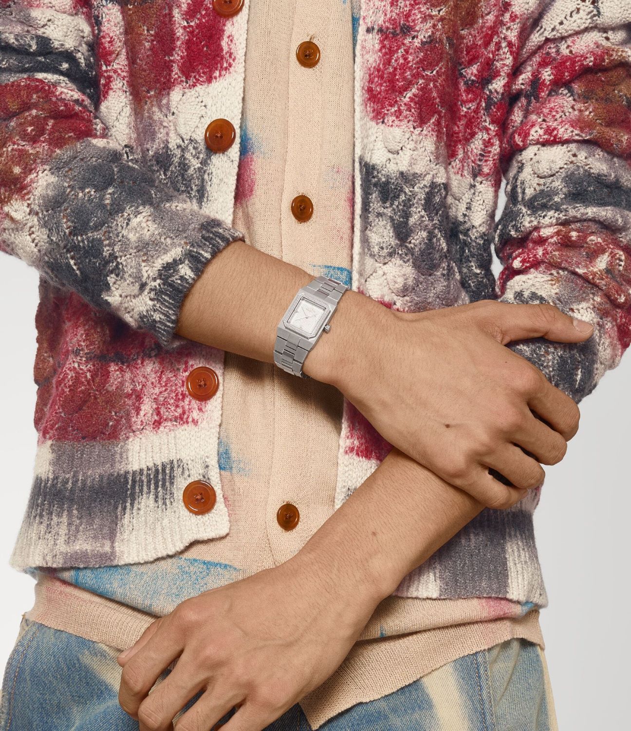 Person wearing a plaid jacket with a Vivienne Westwood Brunswick Grey Dial Silver Watch VV333LGYSL 8050164231897 on a neutral background