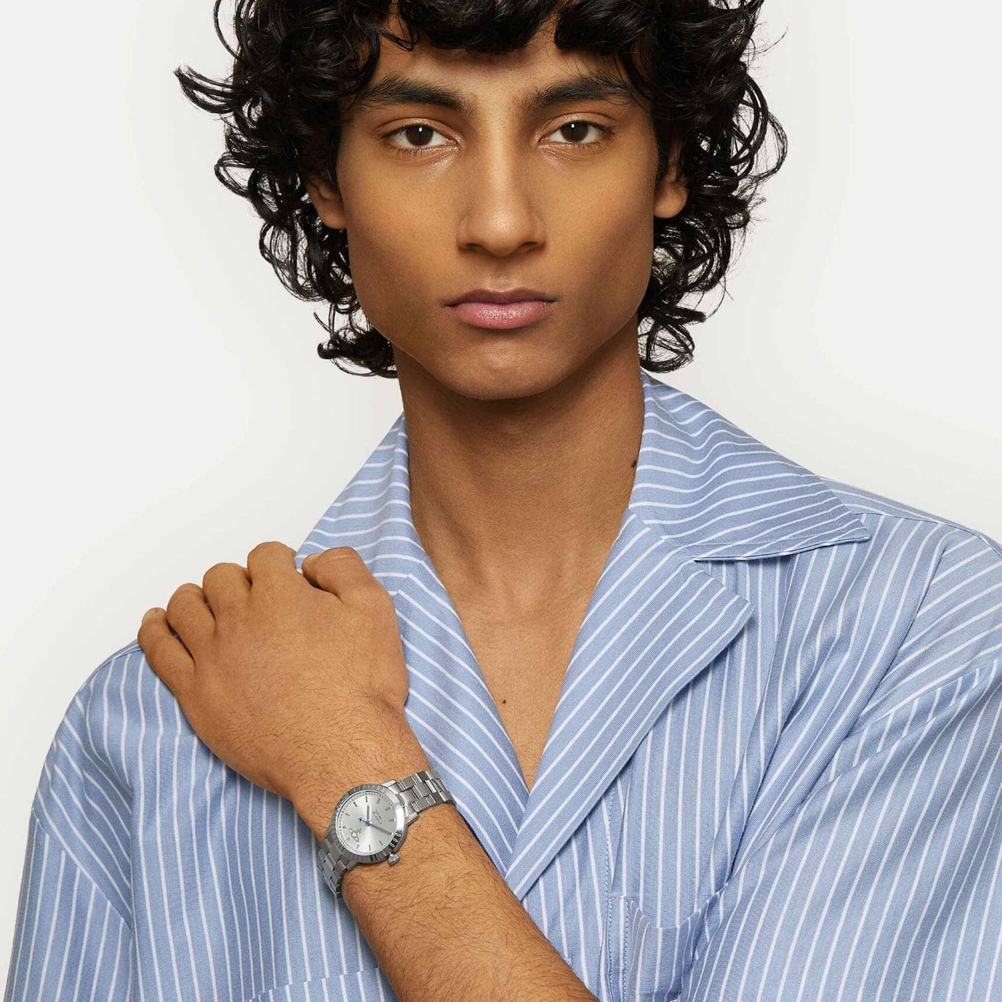 Man wearing a blue striped shirt and Vivienne Westwood Dulwich Silver Watch vv307slsl on a white background