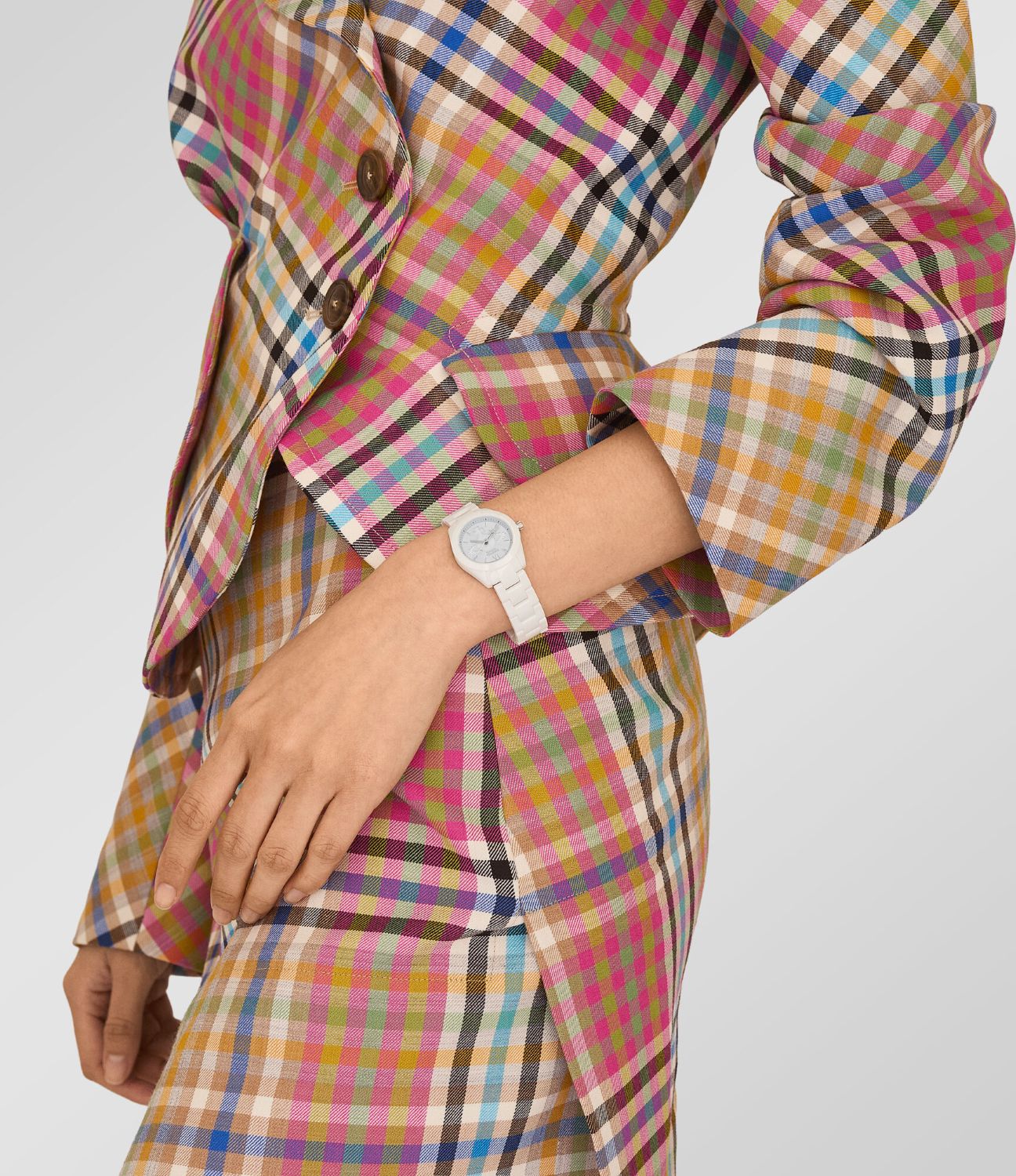 Person wearing a colorful plaid suit with a Vivienne Westwood Fenchurch Ceramica Blue White Watch vv358lblwh 8050164232115 on a plain background