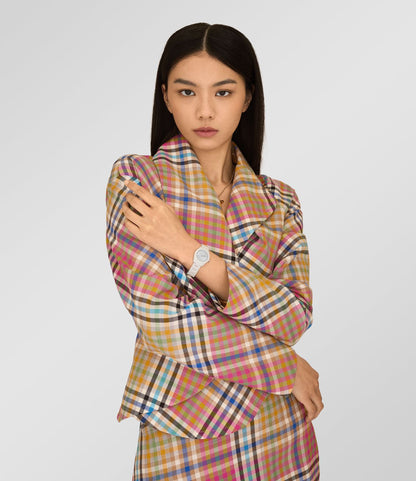 Woman wearing a multicolored checkered outfit with Vivienne Westwood Fenchurch Ceramica Blue White Watch vv358lblwh 8050164232115 on a white background