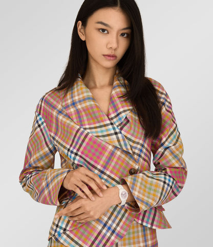 Model wearing a colorful plaid coat with Vivienne Westwood Fenchurch Ceramica Pink White Watch vv358lpkwh 8050164232122 on a plain background