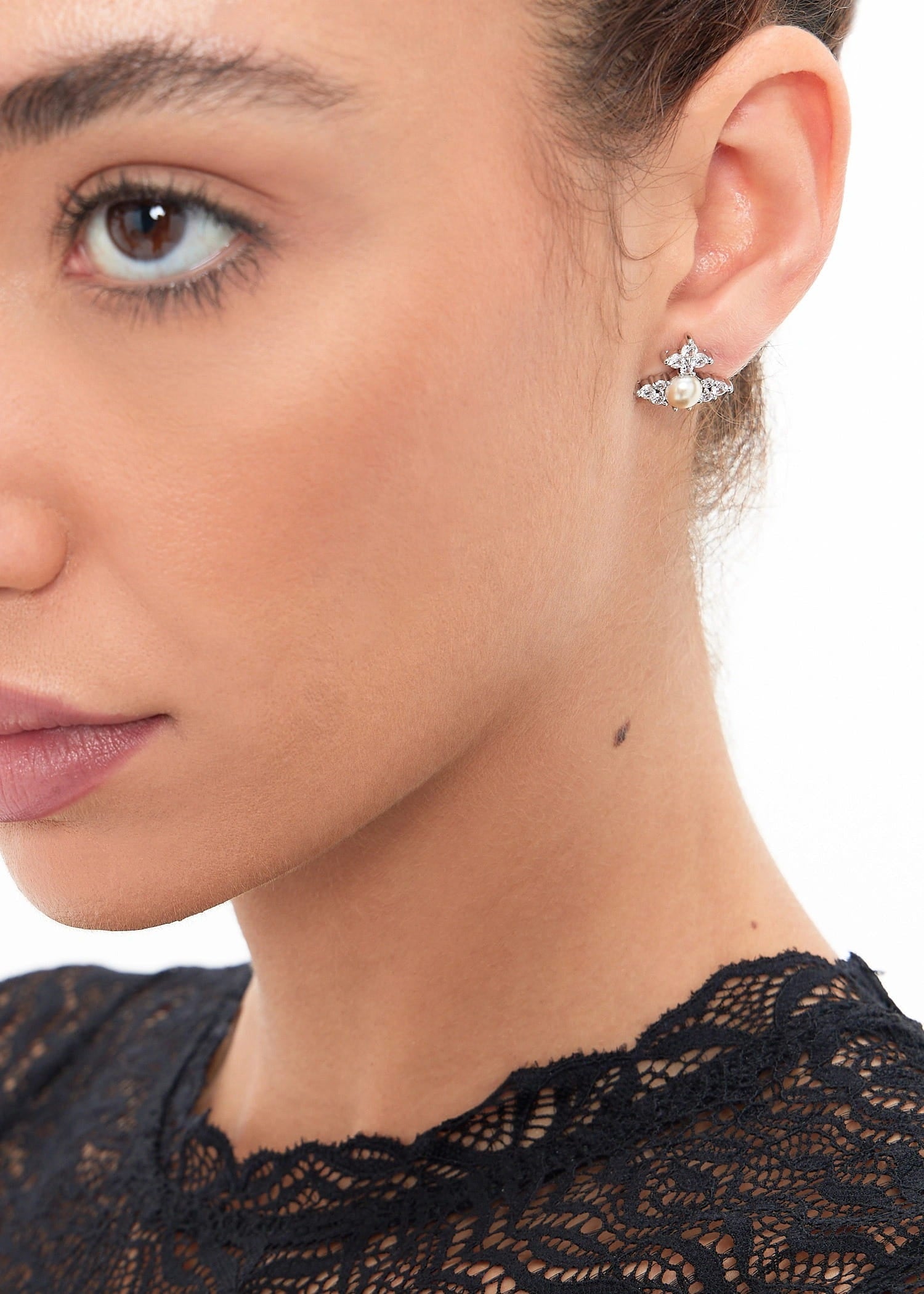 Close-up of a woman wearing a Vivienne Westwood Feodora Earrings Creamrose Pearl 6201034Y-02P373 8050889777670 on a white background