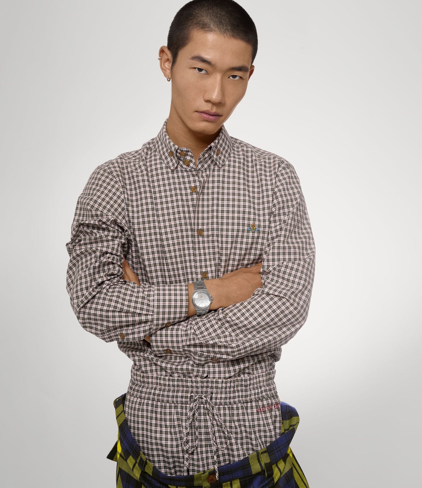 Man wearing a checkered shirt with Vivienne Westwood Hanwell Silver Watch VV335SLSL 8050164231927 on a plain background