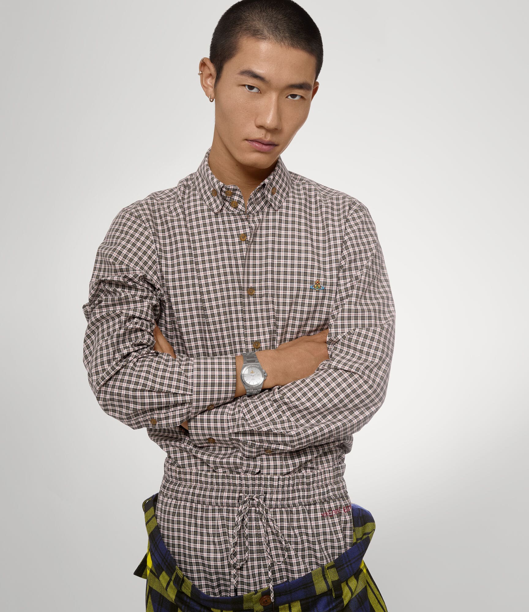 Man wearing a checkered shirt with Vivienne Westwood Hanwell Silver Watch VV335SLSL 8050164231927 on a plain background