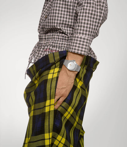 Person wearing a plaid shirt and colorful pants with a Vivienne Westwood Hanwell Silver Watch VV335SLSL 8050164231927 on a plain background